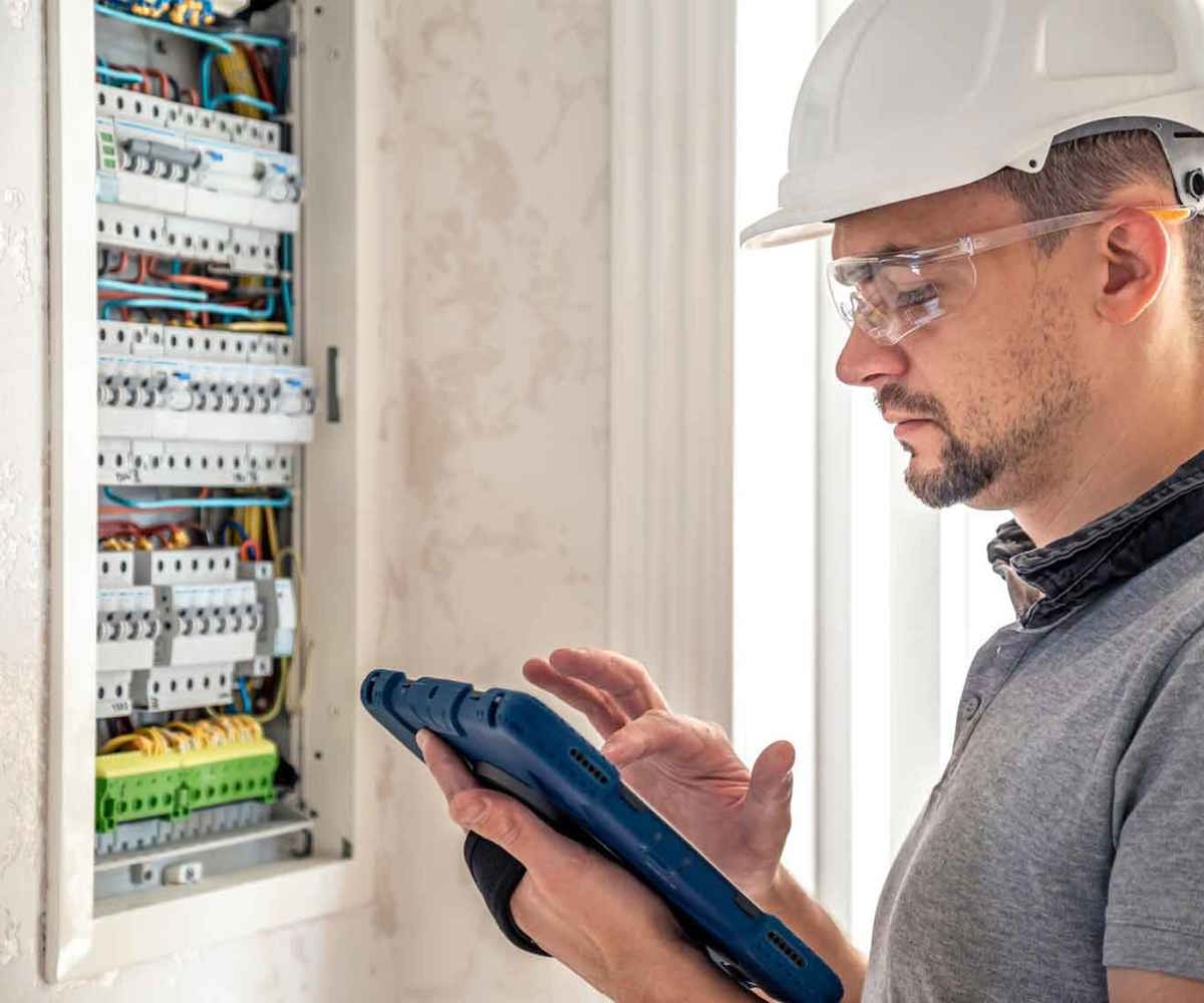 Elektriker kontrollerar elcentral i flerbostadshus